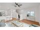 Inviting living room with hardwood floors, a stylish rug, and staircase in the background at 12228 Foxmoor Peak Dr, Riverview, FL 33579
