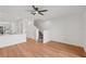 Bright living room featuring hardwood floors, a staircase, and an open view into the kitchen at 12228 Foxmoor Peak Dr, Riverview, FL 33579