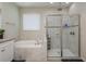 Bright bathroom featuring a glass-enclosed shower and soaking tub at 12451 Nouveau Ave, Spring Hill, FL 34610