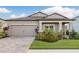 Charming single-Gathering home with a two-car garage, paver driveway, and meticulously maintained landscaping at 12451 Nouveau Ave, Spring Hill, FL 34610