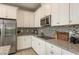 Modern kitchen with stainless steel appliances, stylish backsplash, and granite countertops at 12451 Nouveau Ave, Spring Hill, FL 34610