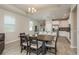 Bright open kitchen and dining area with stainless appliances and a large central island at 12451 Nouveau Ave, Spring Hill, FL 34610