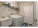 Efficient laundry room featuring modern washer, dryer, and storage at 12451 Nouveau Ave, Spring Hill, FL 34610