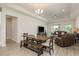 Open-concept living area with wood-look tile floors and neutral color palette at 12451 Nouveau Ave, Spring Hill, FL 34610