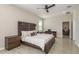 Spacious main bedroom with a dark wood furniture set and well-lit sitting and desk area at 12451 Nouveau Ave, Spring Hill, FL 34610