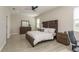 Serene main bedroom featuring a rustic wood bed frame and contemporary furnishings at 12451 Nouveau Ave, Spring Hill, FL 34610
