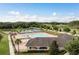 Aerial view of the community pool, clubhouse, tennis and basketball courts, and playground amenities at 12451 Nouveau Ave, Spring Hill, FL 34610