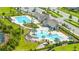 Aerial view of community pools, lounge area, and community center in this resort-style neighborhood at 12652 Shetland Walk Dr, Lithia, FL 33547