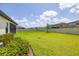 Lush, well-maintained backyard featuring a vibrant green lawn and a white fence for privacy and security at 12652 Shetland Walk Dr, Lithia, FL 33547