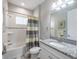 Cozy bathroom featuring granite countertops, neutral color walls, decorative shower curtain, and tiled shower at 12652 Shetland Walk Dr, Lithia, FL 33547