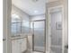 Bathroom featuring modern vanity, granite countertop, updated fixtures, and glass enclosed shower at 12652 Shetland Walk Dr, Lithia, FL 33547