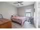 Comfortable bedroom with ceiling fan and hardwood floors, illuminated by natural light at 12652 Shetland Walk Dr, Lithia, FL 33547