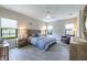 Bright bedroom with a ceiling fan, warm lighting, and wood-look flooring at 12652 Shetland Walk Dr, Lithia, FL 33547