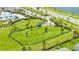 Aerial view of a fenced dog park with lush green grass, offering a secure and fun space for pets at 12652 Shetland Walk Dr, Lithia, FL 33547