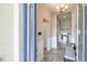 Entryway with wood-look tile flooring, wainscoting, a bench, and views into the living spaces at 12652 Shetland Walk Dr, Lithia, FL 33547