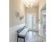 Light and bright entrance hall with bench seating, attractive decor, and wood-look tile flooring at 12652 Shetland Walk Dr, Lithia, FL 33547