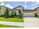 Charming house featuring clean landscaping, a two-car garage, and a covered front entry at 12652 Shetland Walk Dr, Lithia, FL 33547