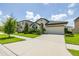 Inviting single-story home with well-manicured lawn, neutral color palette, and attached two car garage at 12652 Shetland Walk Dr, Lithia, FL 33547