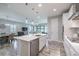 Open-concept kitchen with white cabinets, island with seating, and view into the living/dining spaces at 12652 Shetland Walk Dr, Lithia, FL 33547