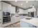 Well-lit kitchen featuring white cabinets, stainless steel appliances, and a functional island at 12652 Shetland Walk Dr, Lithia, FL 33547