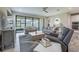 Comfortable living room with oversized windows and wood-look tile flooring at 12652 Shetland Walk Dr, Lithia, FL 33547