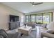 Comfortable living room featuring neutral furniture, ceiling fan, and sliding glass doors to outdoor space at 12652 Shetland Walk Dr, Lithia, FL 33547