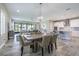 Open living and dining space with bar seating, wood-look tile, and lots of natural light at 12652 Shetland Walk Dr, Lithia, FL 33547