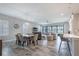 Open living area with dining set, bar seating, and a spacious living room with large windows at 12652 Shetland Walk Dr, Lithia, FL 33547