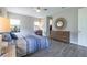 Bright main bedroom with hardwood floors, ceiling fan, walk-in closet and natural light at 12652 Shetland Walk Dr, Lithia, FL 33547