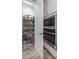 Organized pantry with shelving, storage, and adjacent stainless steel oven at 12652 Shetland Walk Dr, Lithia, FL 33547