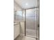 Modern tiled glass shower with granite countertop and updated fixtures at 12652 Shetland Walk Dr, Lithia, FL 33547