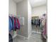 Spacious walk-in closet with custom shelving and ample storage for clothing at 12652 Shetland Walk Dr, Lithia, FL 33547