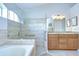 Bathroom features a walk in shower, soaking tub, and a double sink vanity with granite counters at 13602 Fawn Ridge Blvd, Tampa, FL 33626