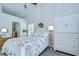 Bright bedroom featuring nautical themed bedding, vaulted ceiling, and an adjacent bath at 13602 Fawn Ridge Blvd, Tampa, FL 33626
