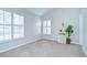 Bright bedroom with neutral carpet, plantation shutters, and a decorative accent table at 13602 Fawn Ridge Blvd, Tampa, FL 33626