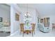 Cozy dining area with chandelier and views of the living area at 13602 Fawn Ridge Blvd, Tampa, FL 33626