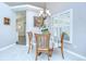 Cozy dining area with chandelier and views of the living area at 13602 Fawn Ridge Blvd, Tampa, FL 33626