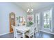 Dining room featuring a grand grandfather clock, elegant furnishings, and plantation shutters at 13602 Fawn Ridge Blvd, Tampa, FL 33626