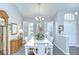 Bright dining room with elegant white table set and plantation shutters allowing for plenty of natural light at 13602 Fawn Ridge Blvd, Tampa, FL 33626