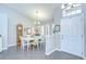 Inviting dining room with wood-look tile floors, bright natural light, and stylish chandelier at 13602 Fawn Ridge Blvd, Tampa, FL 33626
