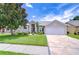 Charming single-story home with manicured landscaping, stone driveway, and an attached two-car garage at 13602 Fawn Ridge Blvd, Tampa, FL 33626