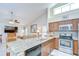 Open kitchen with granite countertops, stainless steel appliances, and breakfast bar seating overlooking the living area at 13602 Fawn Ridge Blvd, Tampa, FL 33626