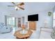 Bright living room with neutral paint, tile floors, and large windows offer a relaxing space at 13602 Fawn Ridge Blvd, Tampa, FL 33626