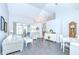 Bright living room with vaulted ceilings, sliding glass doors, and stylish white furniture at 13602 Fawn Ridge Blvd, Tampa, FL 33626