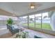 Relaxing screened-in patio with wicker furniture, ceiling fans, and views of the landscaped backyard at 13602 Fawn Ridge Blvd, Tampa, FL 33626