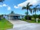 Charming single-story home with carport and lush landscaping at 13931 King Ave, Hudson, FL 34667