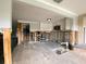 Kitchen featuring exposed studs, modern cabinets, and stone flooring at 13931 King Ave, Hudson, FL 34667