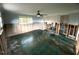 Living room in renovation with ceiling fan and bright window at 13931 King Ave, Hudson, FL 34667