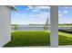 Expansive backyard with lush lawn and serene lake views at 1583 Running Tide Pl, Sarasota, FL 34240