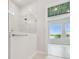 Modern shower featuring marble tile and glass door leading to bedroom at 1583 Running Tide Pl, Sarasota, FL 34240